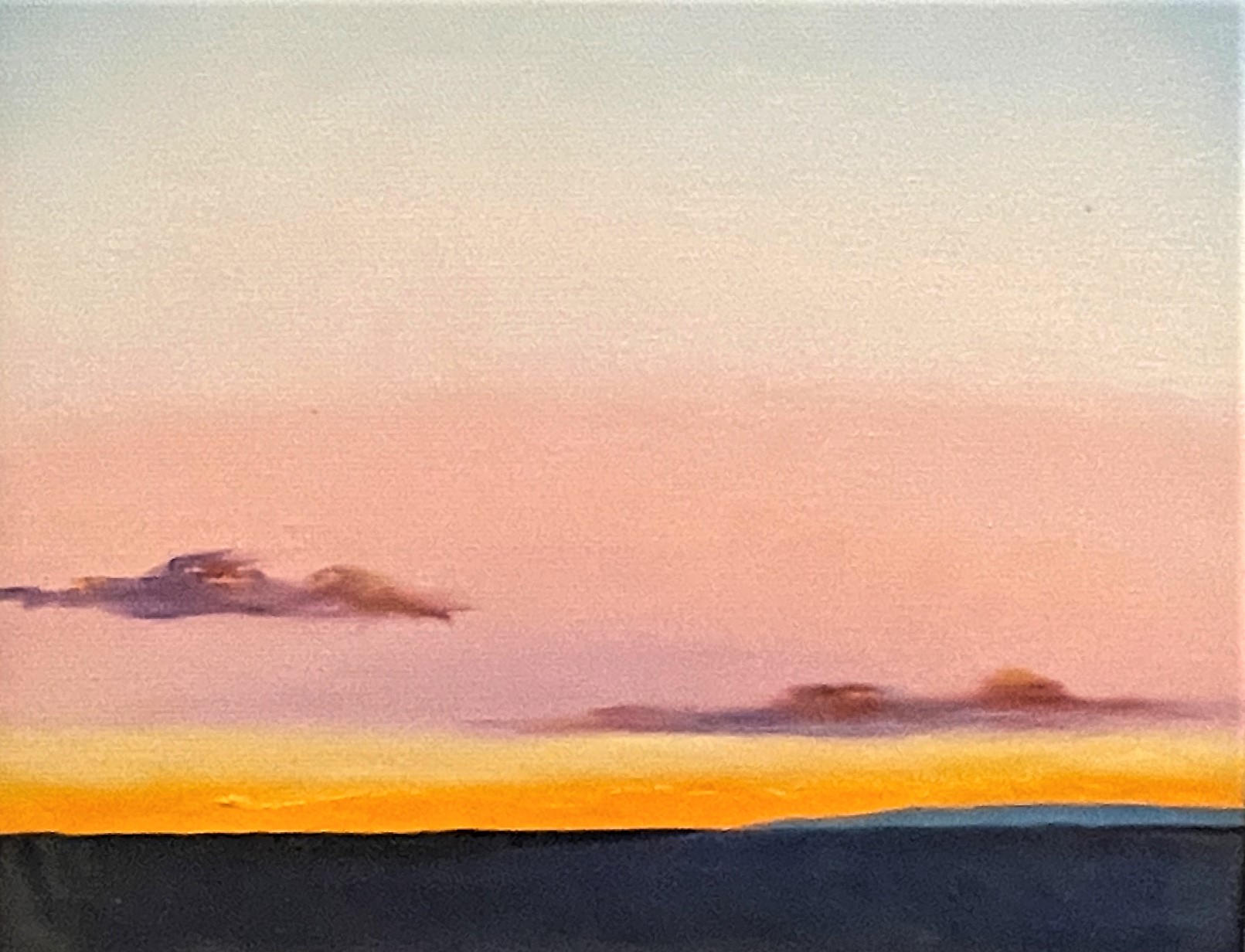 painting of pink and orange sunrise sky over the desert