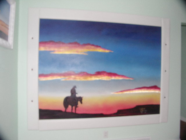 painting of cowboy on a horse at sunset